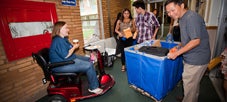 Wheelchair student getting help