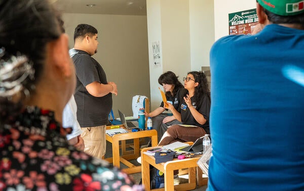 Stonewall check in desk talking with student