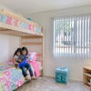 A child reads in their bedroom at Oban Family Housing.