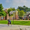 Students play basketball on the courts at the Stonehaven Campus Apartments.