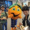 Students pose with Norm the Navel mascot.